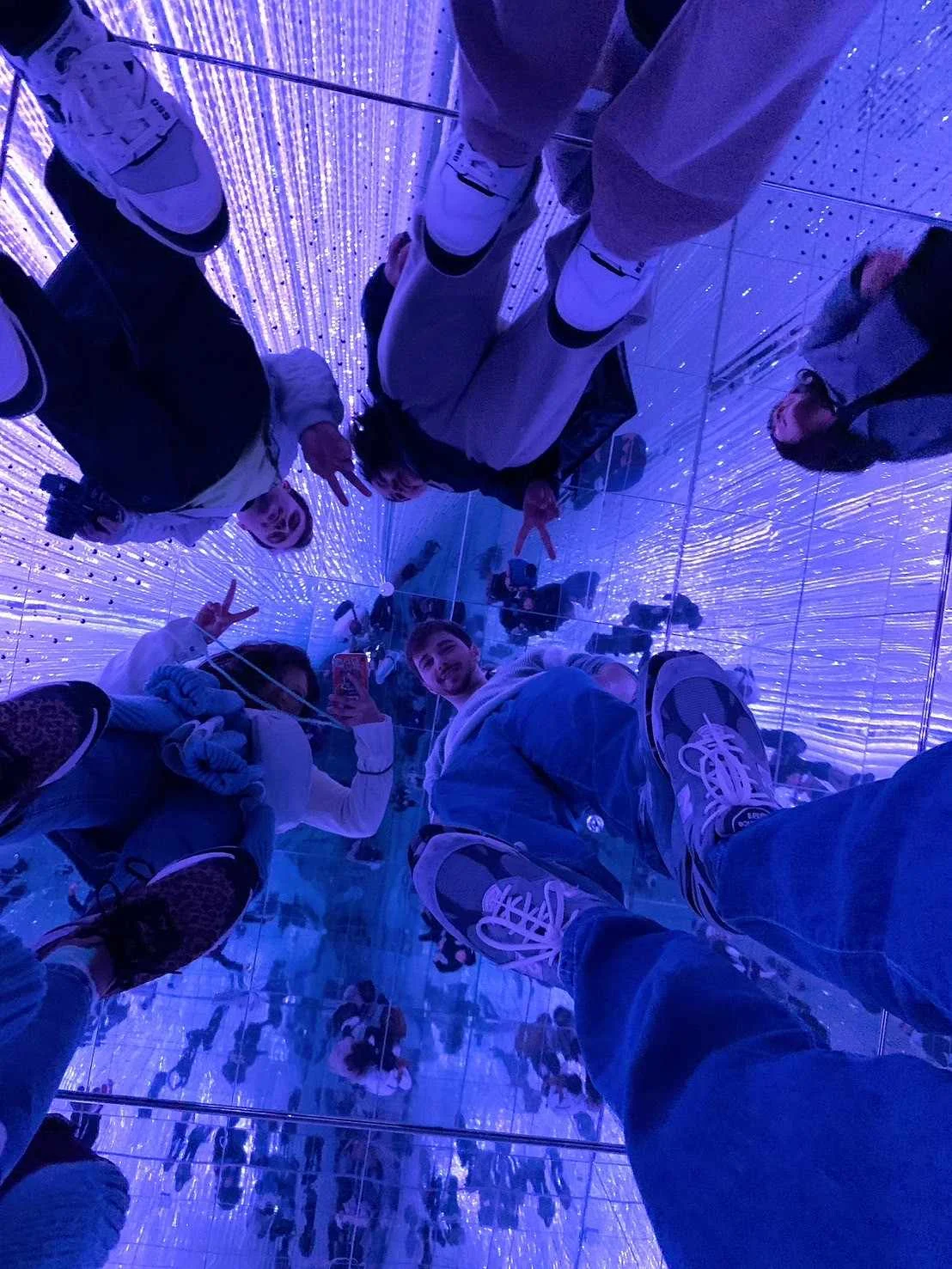 Large open room with mirrors reflecting the lights